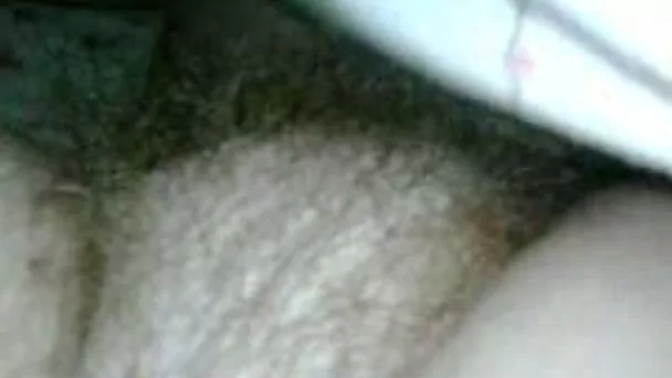 Playing with her hairy snatch and pink nipples on cam