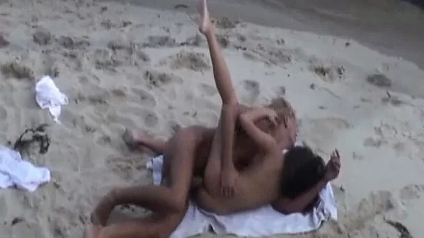 Amazing sex of a young white couple on the nude beach