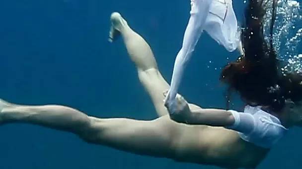 Slender and young redhead harlot in the deep blue sea