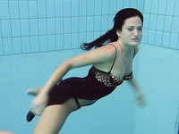 Pure dark brunette beauty underwater in the pool on cam