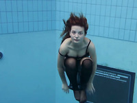 Redhead crazy teen beauty undresses under water in the pool