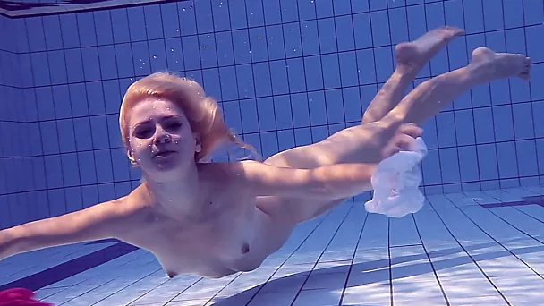 Russian sweet blonde girl undresses in the pool and shows her pussy