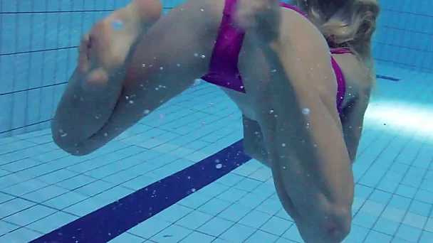 Blonde and naughty teen babe imitates mermaid underwater