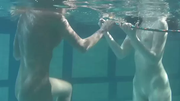 Two lovely white fresh girls playing in the pool nude