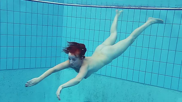 Busty redhead European college girl in the pool naked