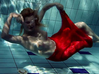 Blonde busty European teenie in red dress underwater