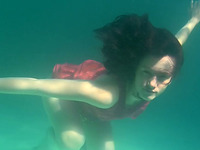 Luscious Russian brunette teen getting topless underwater