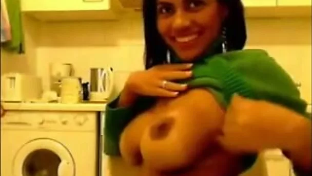 Seductive Indian beauty exposes her big tits and smiles