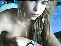 Cute blonde gal caressing her titties while on webcam with me