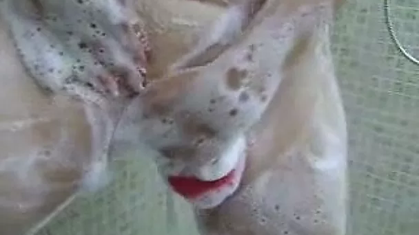 My kinky girlfriend plays with her foamed sexy natural boobies