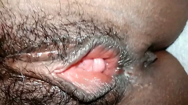 Fingering and stretching my ebony GF's hairy punani in closeup video