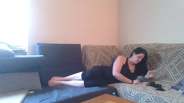 Lustful brunette flatmate masturbating on a couch
