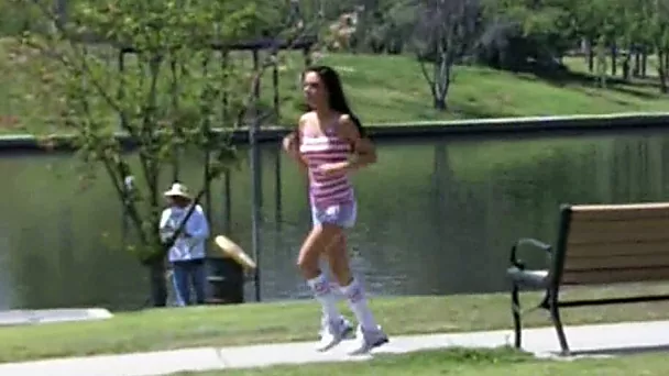 Cute and sporty brunette sweetie jogging in the park