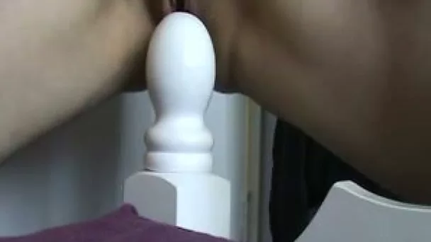 My sexy wife rides our bed and inserts a fist in her cunt