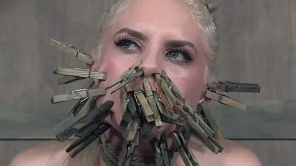 Blonde slender white chick got her face clipped with cloth pins