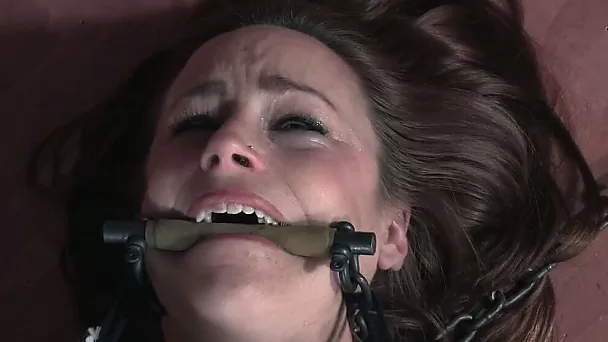 Sweet auburn haired white girl chained and gagged with wooden stick