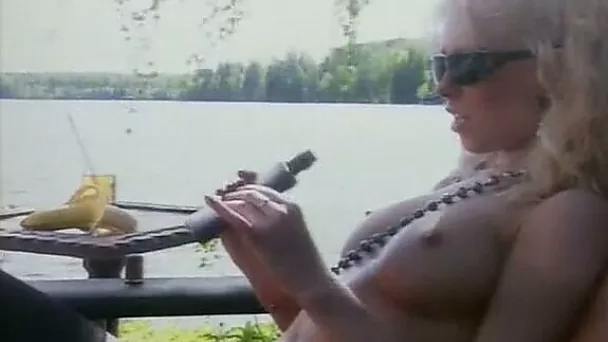 Sassy and busty blonde bimbo on the lounger masturbating
