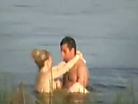 A horny couple was fucking in a standing position in the lake