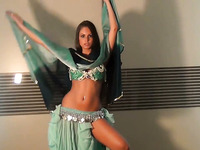 Well shaped girlie dancing seductively in eastern dress