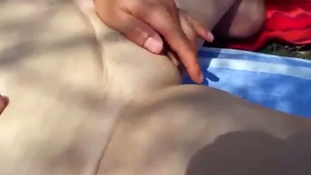 Pale skinned teen with big boobs finger fucked on a lawn outdoor