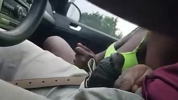Amateur black girlfriend in the car sucking dick while he is driving