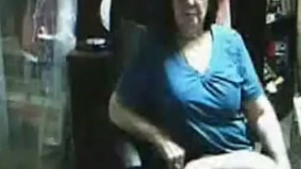Red haired granny likes to show off her big tits and pussy
