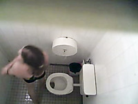 Spy video from a swimming pool toilet - babe takes a piss