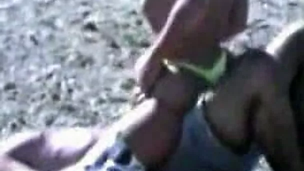 Voluptuous bikini babe sucks her partner's cock on the beach