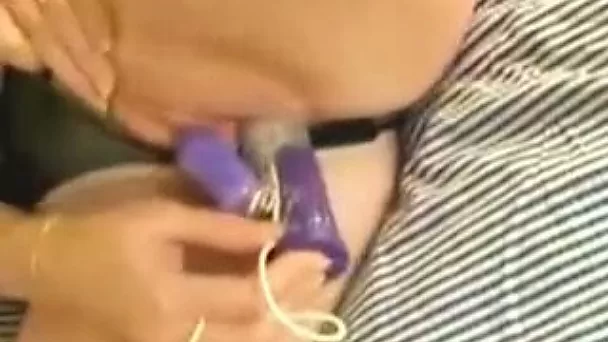 Fine white sexy redhead milf on the bed pokes her pussy with a vibrator