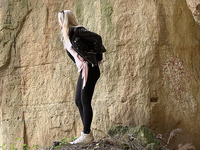 Straight blond haired cutie leans over the rock and pees right away