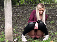 Cute long haired blonde chick pulls down her black pants and pisses