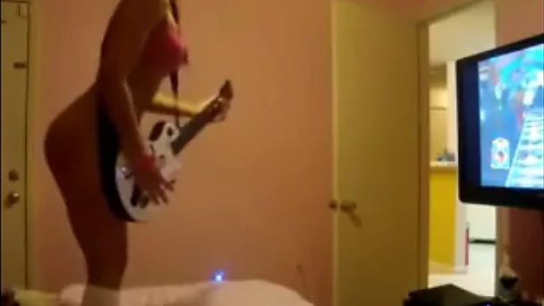 Frisky amateur flatmate playing with my guitar in amateur clip