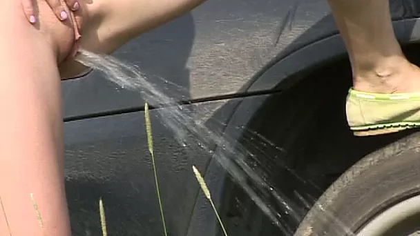 Svelte redhead flashes tits and pisses near the car outdoors