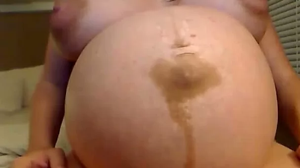 This stacked camgirl is obviously pregnant and loving it