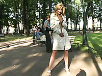 Blonde adorable Russian girl in white raincoat shows off her pussy