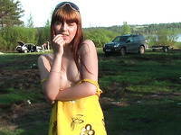 Magnificent redhead beauty in yellow dress flashes goodies outdoors