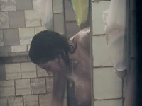 Brunette cute stranger girl in the shower room filmed nude on voyeur video
