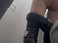 White chick in tight jeans and black leather boots filmed from behind
