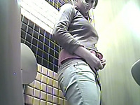 Hidden cam in the ladies room catches young brunette