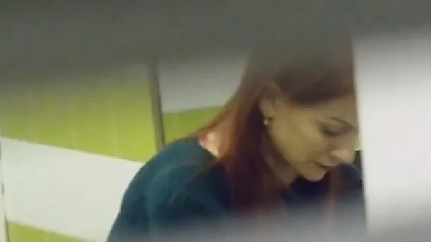 Beautiful redhead stranger girl filmed in the public restroom