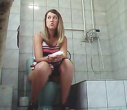 Blonde amateur lady in sexy dress pisses in the toilet room