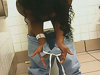 Curly haired black woman in the public restroom filmed on cam