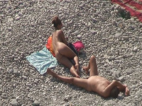 Sweet girlfriend and her man were sunbathing nude on the beach