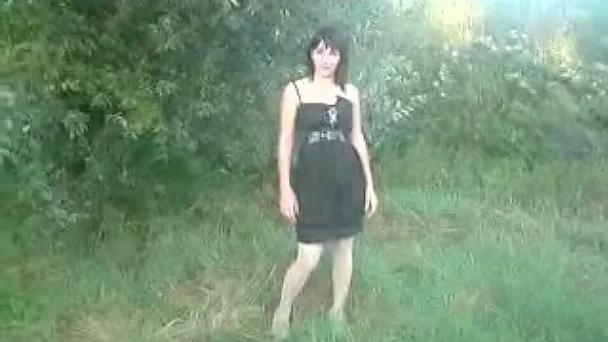 Lewd looking like a vampire brunette poses in her white lingerie outdoors