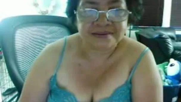 Mature curly short haired brunette webcam nerdy whore posed in her blue top