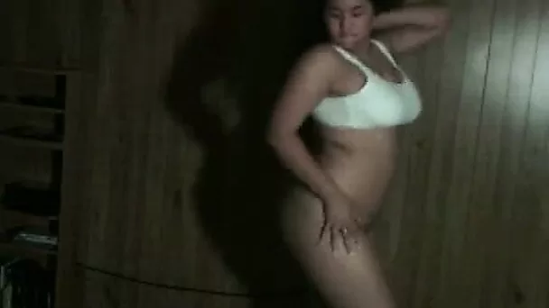 Curvy brunette is dancing and taking off her clothes