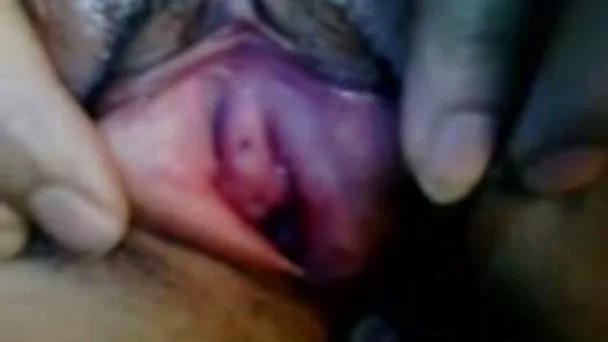 Trashy black hoe stretching her pussy lips with fingers