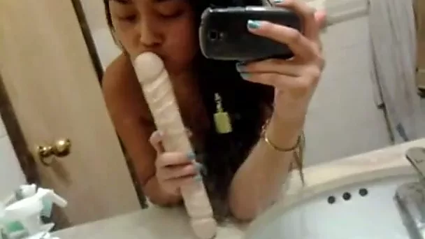 Cute Asian girl flashed her natural tits while masturbating in the bathroom