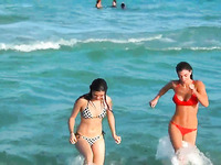 Two lesbians are looking to have a fun and swim in the ocean