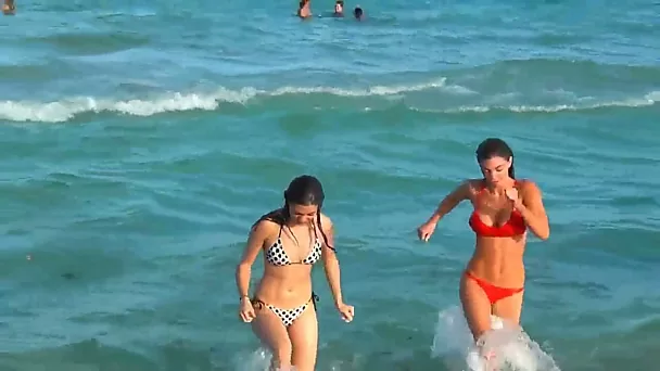 Two lesbians are looking to have a fun and swim in the ocean